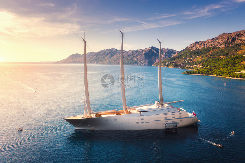 豪华游艇蓝色海洋五颜六色的日落夏天大型现代帆船的鸟瞰图美丽的未来派游艇,泻湖,船,山,清澈的水,天空亚得里亚图片
