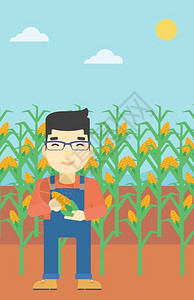 一位持有玉米的农民图片