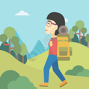 在山上徒步的女性背包客图片