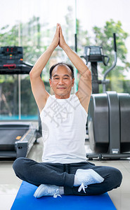 老年男子在健身房练瑜伽背景图片