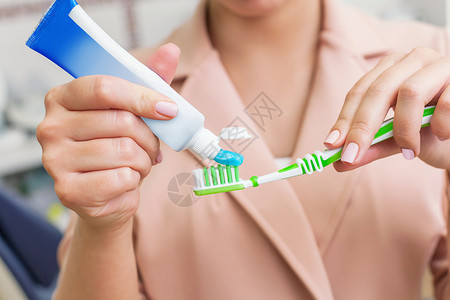 女人在牙刷上涂牙膏图片