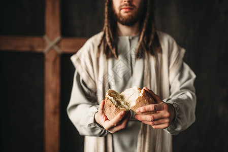 基督为信仰者提供面包神圣的食物在背景上图片