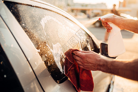 男子洗车用毛巾擦玻璃图片
