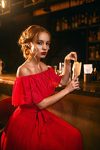 红裙子美女在酒吧柜台喝鸡尾夜店约会有魅力的情侣图片