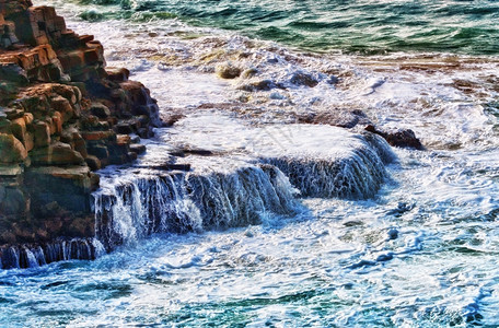 海浪撞击岸的岩石图片