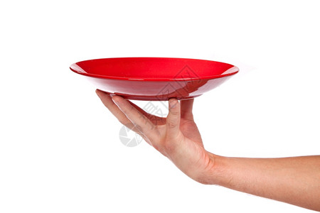 红色厨房餐具手持红色厨房餐盘在白色背景上隔离图片