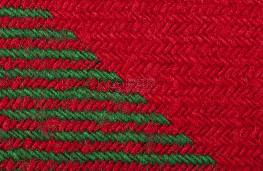 亲手编织的绿色和红背景关闭缝线结构圣诞颜色图片