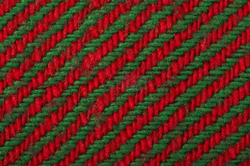 亲手编织的绿色和红背景关闭缝线结构圣诞颜色图片