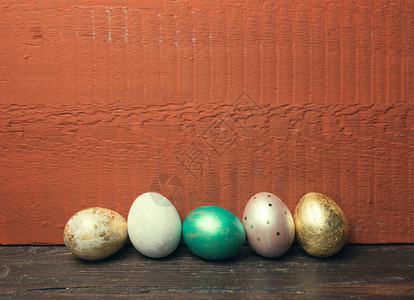 砖红色背景的彩色鸡蛋背景图片