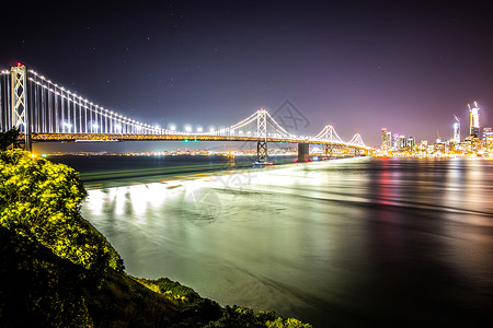 晚上在加州的奥克兰湾桥与圣弗朗西斯科的天际连线岛高清图片素材