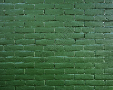 深绿色油漆砖墙上的抽象图案一部分图片