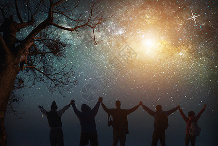 夜晚的天空与星和欢乐的人们一起站立在空中举起手来蓝色的乳白天空与山上人一起与宇宙的背面夜晚光景旅行自由的概念背景图片