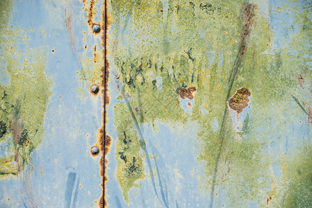 古背景旧生锈金属表面涂有蓝色和绿料粉破碎纹理有接缝和图片
