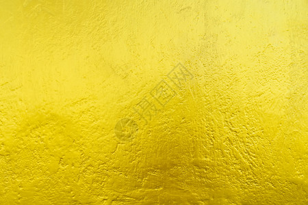 从金色的墙壁纹理和阳光的抽象背景奢侈和优雅的墙纸图片