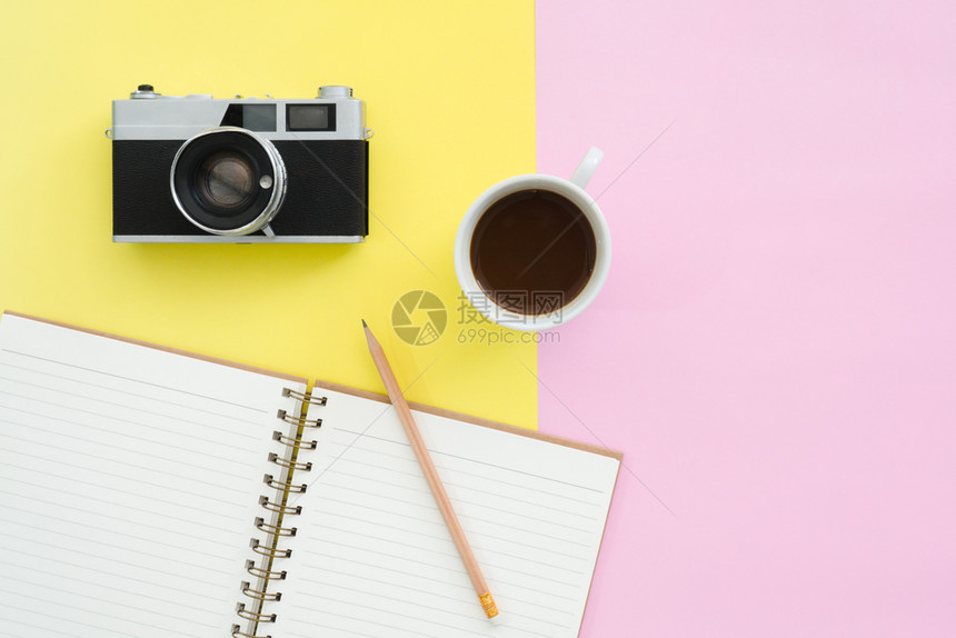 夏季旅行概念的固定设计平板粉色和黄面纸彩屏幕上的白纸笔记本咖啡和照相机的顶端视图模型并配有复制空间图片