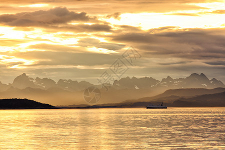 血淋淋的夕阳笼罩着大海和山峰高清图片