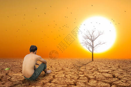人坐在地上靠近干燥的陆地和热干燥的空气图片