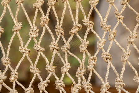 传统渔网上的结的特写镜头由绳子打结而成渔网新结绳线的抽象设计背景图片
