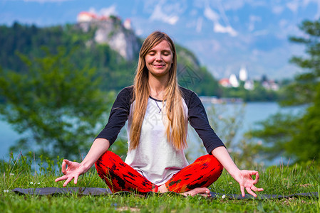 在湖边做瑜伽的女人背景图片