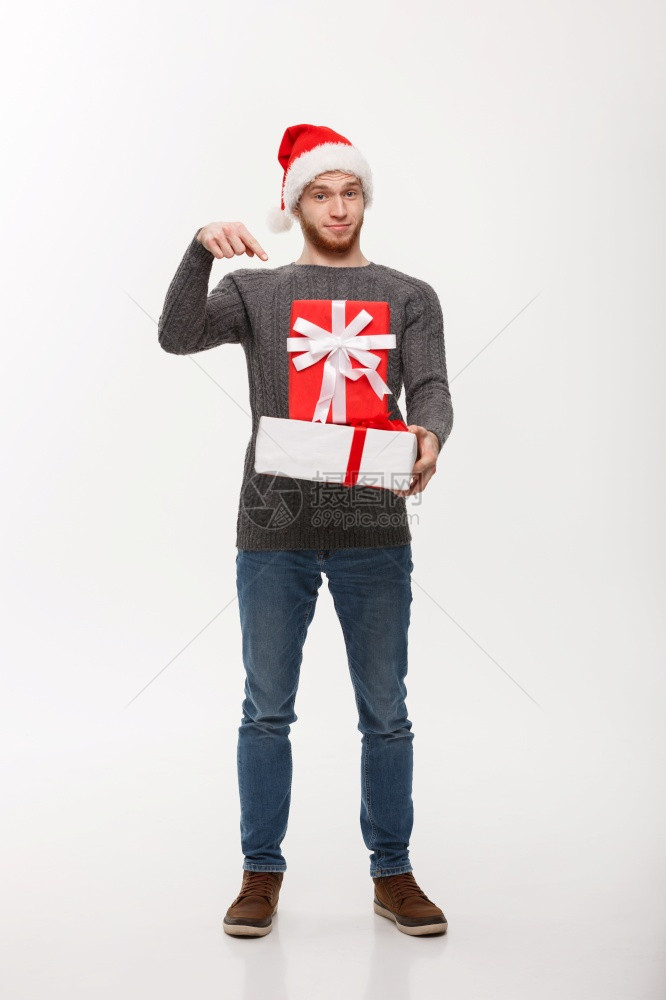 圣诞节概念快乐的年轻人胡子指着手与白种背景隔绝图片