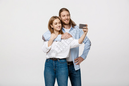 快乐的情侣用手机自拍图片