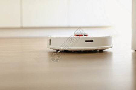 在室内客厅用层地板清洗粉尘的白色机器人吸尘智能电子家用技术智能在室内层地板清洗粉尘的白色机器人吸尘智能家用技术背景图片