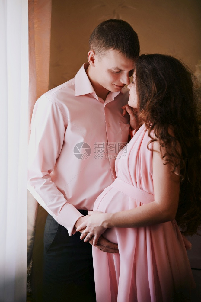 丈夫温柔地拥抱其怀孕的妻子着婴儿图片