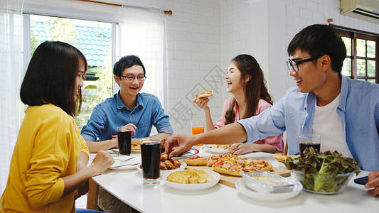 asi家庭聚会吃披萨欢笑饭坐在餐厅桌旁庆祝节假日和聚会图片