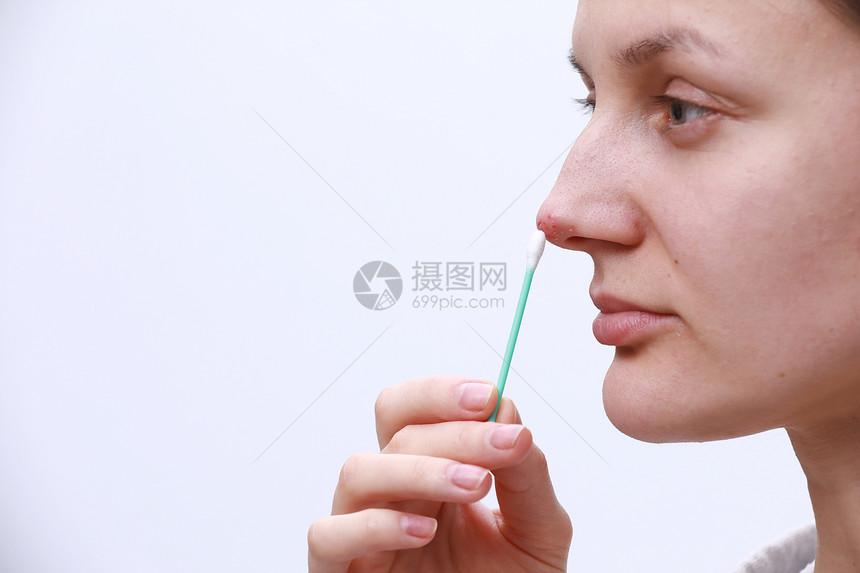 鼻部的疹子漂亮的年轻女妇她拿着一个耳棒并携带了疹子药物人类鼻部的近子内含了乳腺的简单病菌感染和泡鼻部的疹子漂亮年轻女内含一个耳棒图片