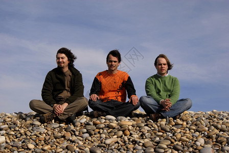 海滩上的三个青年男子背景图片