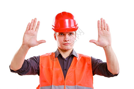 年轻建筑工人匠头穿着橙色安全背心和红硬帽手势停止在白色上隔离工业作没有安全进入工作室中工头高清图片素材