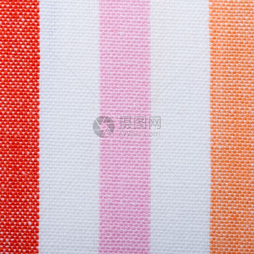 彩色的红粉橙条纹织布纺作为背景纹理或图案Micro图片