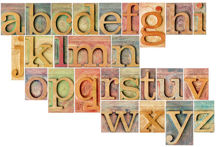英文完整小写字母表由26个孤立的古木纸质印刷块拼贴用彩色墨水染背景图片