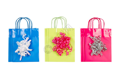 粉红色绿和蓝的新购物礼品袋上面有白色的丝带上面是白色的图片