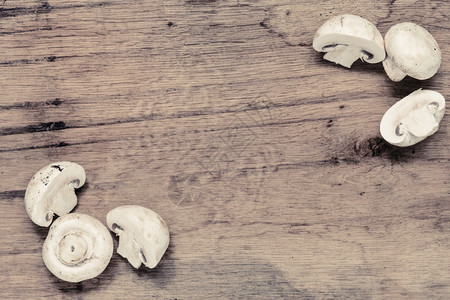 蔬菜食品新鲜白色蘑菇框架木制厨房餐桌背景的冠军背景图片