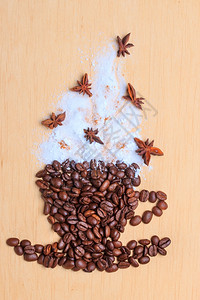 卡布奇诺时间烤咖啡豆以杯子和白霜火鸡蛋装饰形式放在木制表面背景上图片