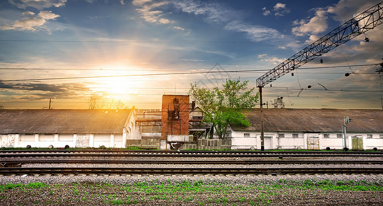 日落时的铁路和工业站图片