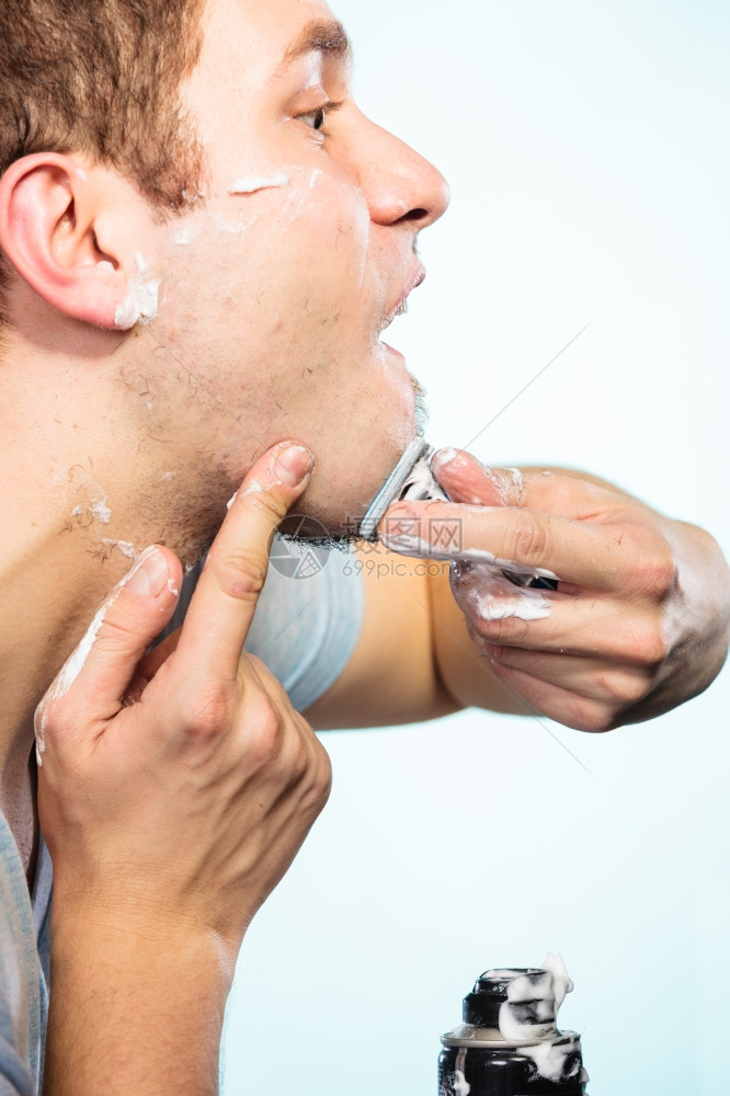 健康美貌和皮肤护理概念关闭年轻胡子男脸部涂着泡沫剃须刀脸部涂着蓝色背景图片