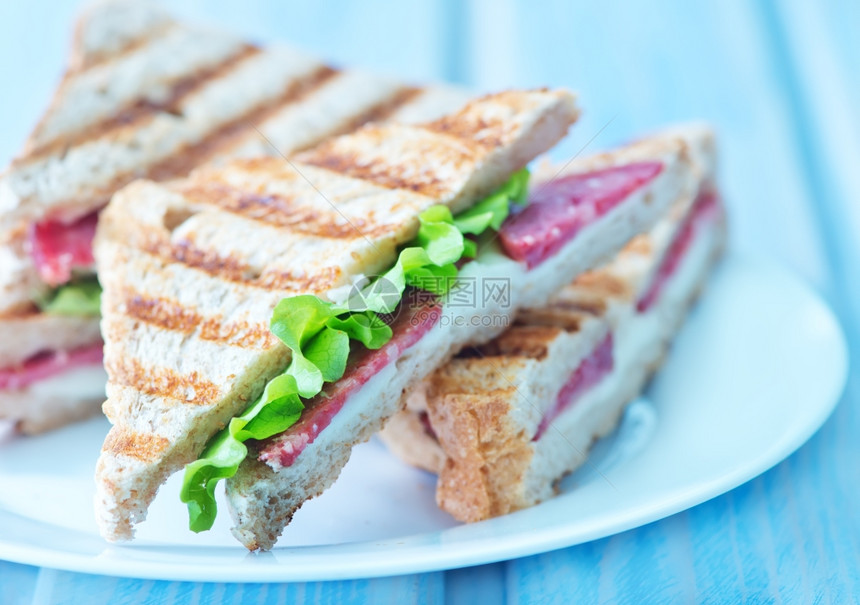 盘上和桌的三明治图片