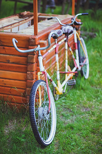 一辆双人自行车停在草坪的围墙上图片