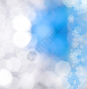 装饰蓝色圣诞节背景带有bokeh灯光和雪花图片