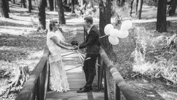 新娘和郎在木桥上牵手的快乐新娘和郎的照片图片
