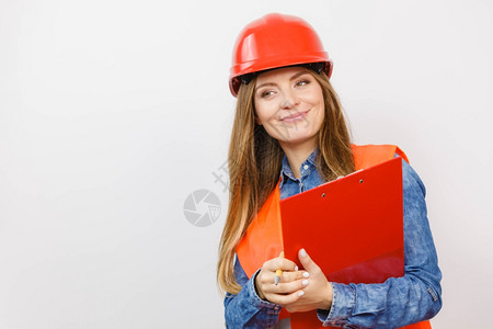 女建筑工人结构程师穿橙色背心红硬头盔的建筑工结构程师持有笔文件垫工业作安全室中技术的高清图片素材
