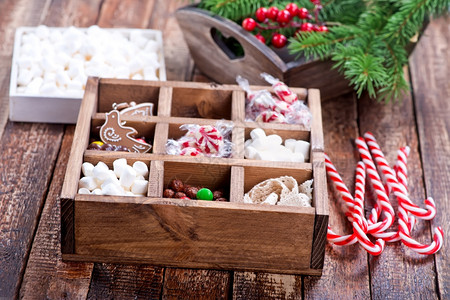 圣诞糖果装在盒子和桌上图片
