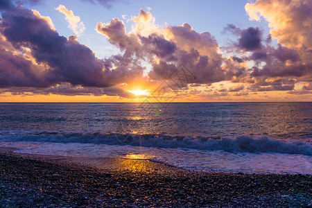 索契黑海岸滩日落浪在沙滩上爆发背景图片