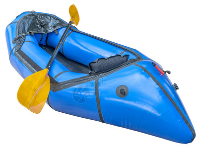 蓝色背包用于探险或赛的单人轻型木筏用白色和剪切路隔开的桨图片