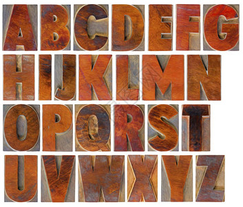 英文大写字母组由26个带有数字绘画效果的孤立古木纸质印刷块拼图背景图片