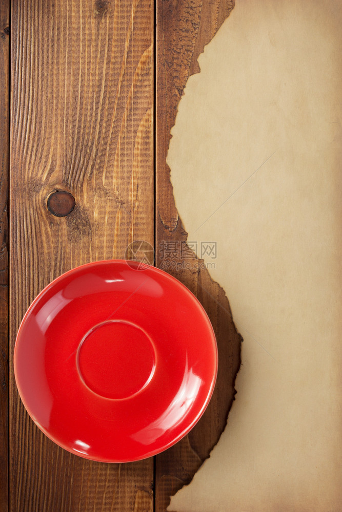 木制背景的红碟和旧纸板图片