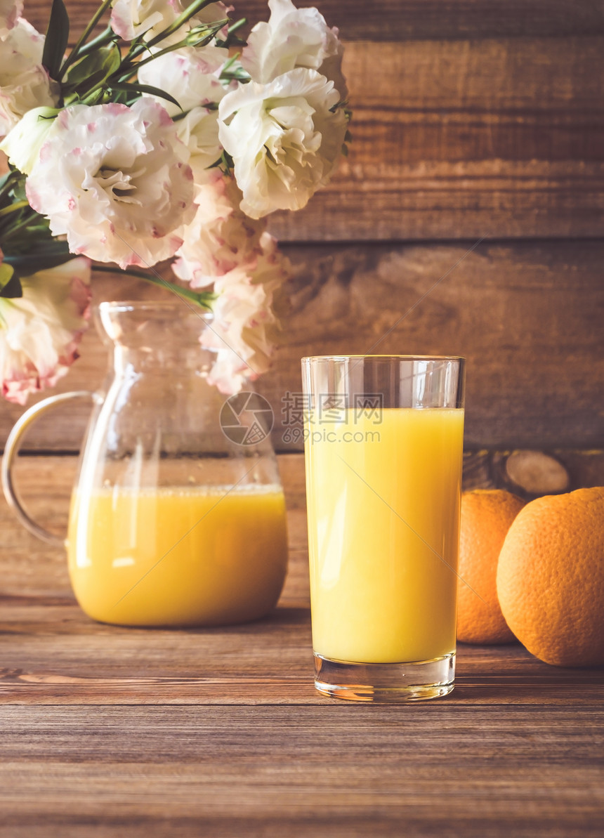橙汁杯子木制背景上鲜橙子图片
