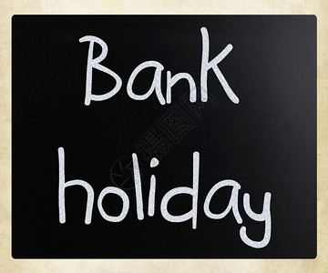银行假日手写白色粉笔在黑板上笔记高清图片素材